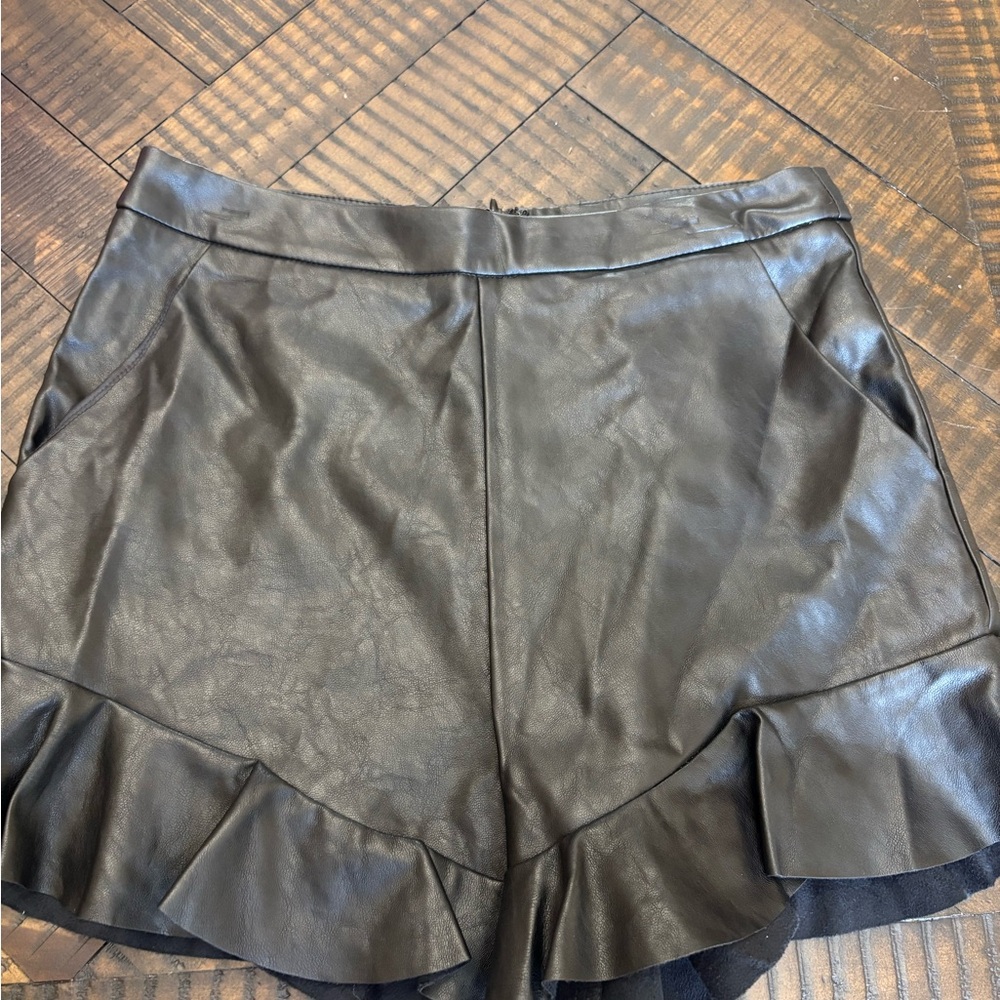 Beau Tissu Black Faux Leather Shorts with ruffle detail
